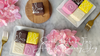 Gift set with colorful petit fours, tea, and pink flowers.