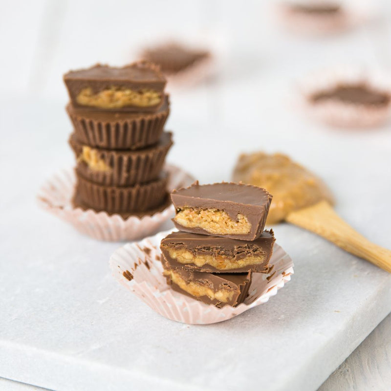 Chocolate cups with a creamy filling on a white surface
